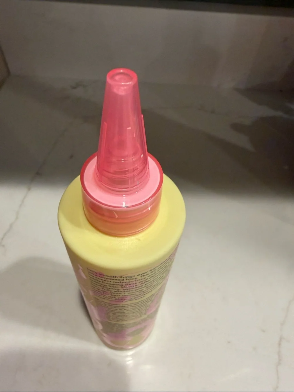 amika Smooth Over Frizz-Fighting Treatment — Yellow & Pink Bottle